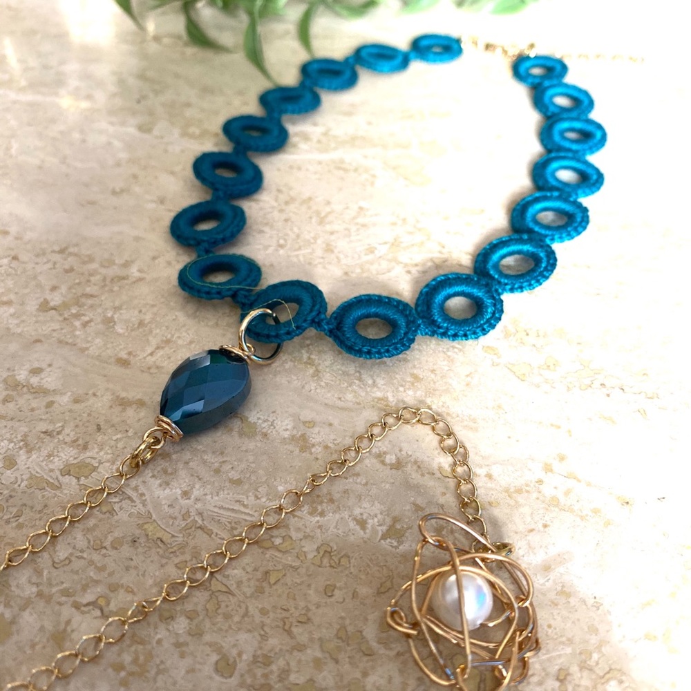 Turquoise crochet choker with pendant.